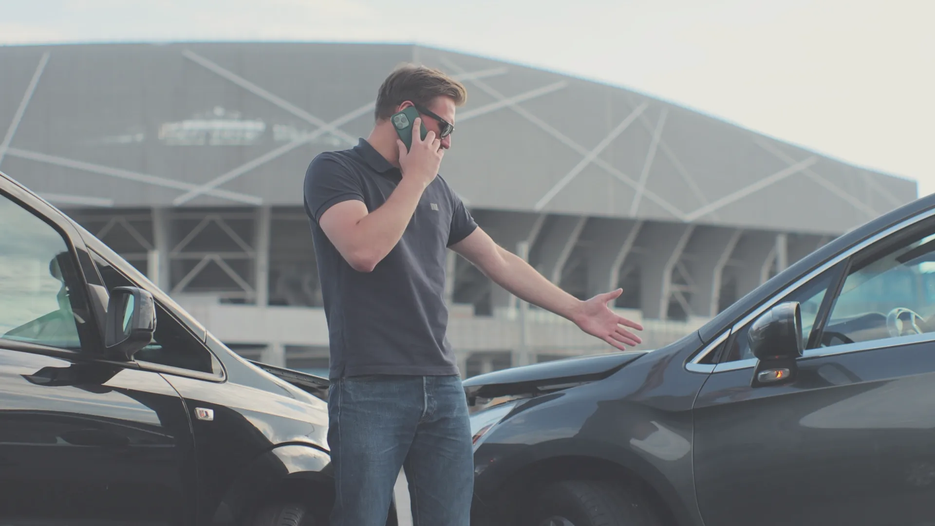 an upset man on the phone who just got into an accident with an uninsured driver